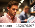 Young man shopping for clothing in a retail store with vibrant colors 132076807