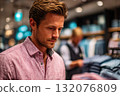 Man shopping for clothing in retail store with colorful apparel displays 132076809
