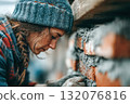 Skilled woman mason working on brick wall with mortar and tools nearby 132076816