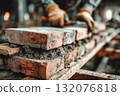 Skilled worker laying bricks with mortar on construction site for building 132076818