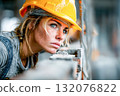 Female construction worker focused on project with safety helmet on site 132076822