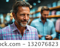 Mature man shopping for clothing in stylish retail store environment 132076823