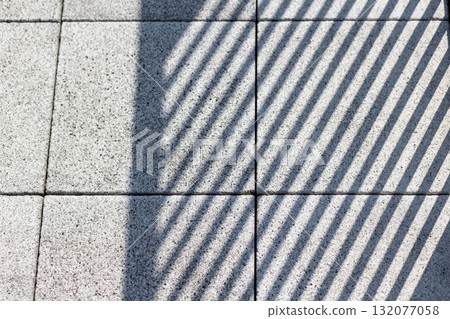 Striped shadows on a tile floor Striped shadows on a tile floor 132077058