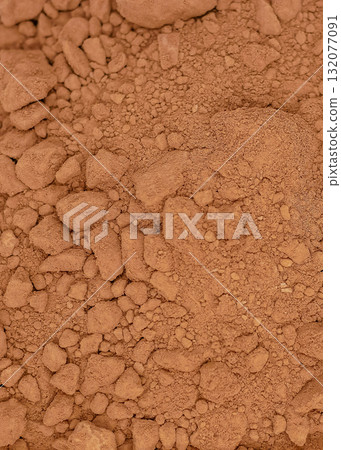 A close-up view of cocoa powder with a textured surface 132077091
