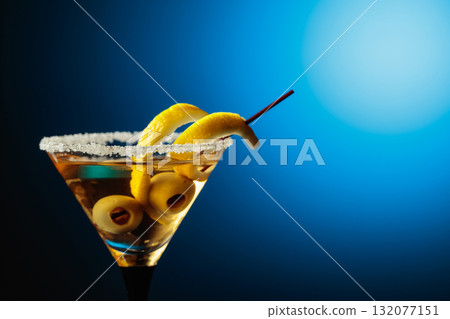 Glass of Martini with green olives and lemon peel. Glass of Martini with green olives and lemon peel. 132077151