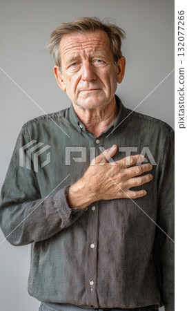 senior man with a serious, thoughtful expression standing with his hand placed over his heart. This image effectively conveys concepts of allegiance, patriotism, loyalty, commitment, sincerity, oath senior man with a serious, thoughtful expression standing with his hand placed over his heart. This image effectively conveys concepts of allegiance, patriotism, loyalty, commitment, sincerity, oath 132077266