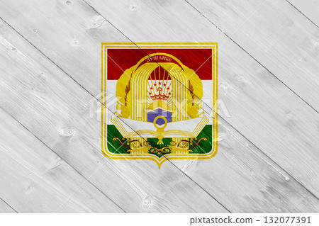 The official flag of Dushanbe, the capital of Tajikistan, on wood texture. Conceptual collage 132077391