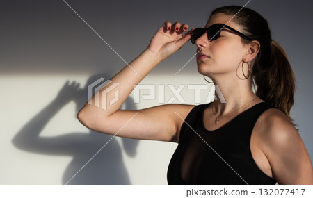 Modern portrait in warm light with soft shadows, ideal for branding, editorial, and social media use Modern portrait in warm light with soft shadows, ideal for branding, editorial, and social media use 132077417