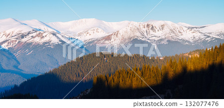 Scenic image of snowy peaks in the sunlight. Location Carpathian national park. Scenic image of snowy peaks in the sunlight. Location Carpathian national park. 132077476