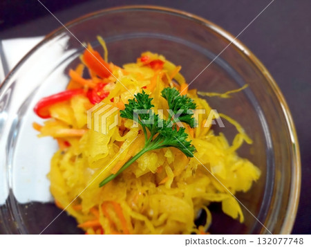 Fresh Salad With Parsley, Cabbage, and Sweet Pepper Served in a Glass Bowl 132077748