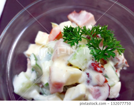 Delicious Salad With Potatoes, Cheese, Meat, Mayonnaise, and Fresh Parsley Served in a Bowl Delicious Salad With Potatoes, Cheese, Meat, Mayonnaise, and Fresh Parsley Served in a Bowl 132077750