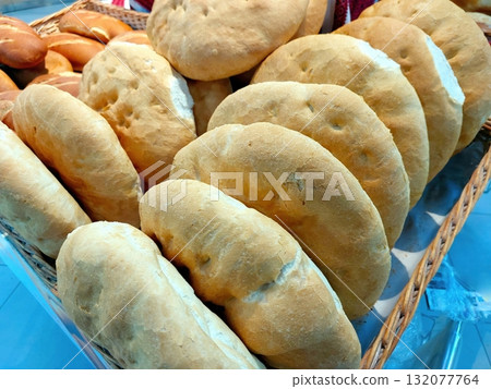 Freshly Baked Wheat Bread Arranged Neatly in a Basket at a Local Bakery Market 132077764