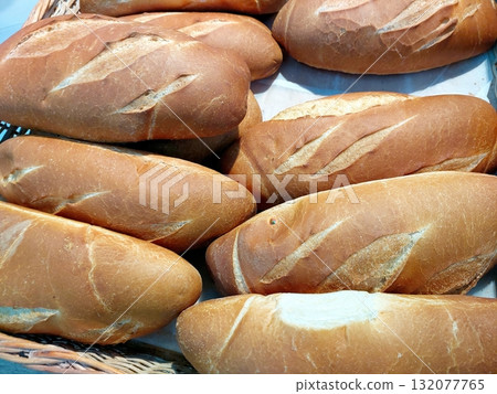 Freshly Baked Wheat Bread Rolls in a Rustic Basket From a Local Bakery in the Early Morning 132077765