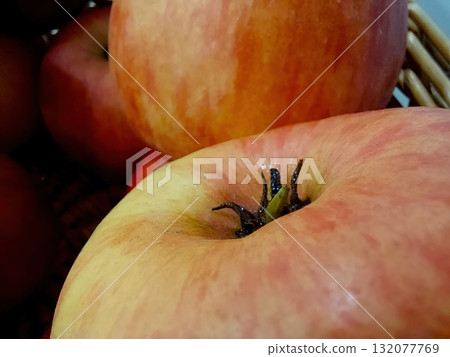 Fresh Red Apple in a Basket With Hints of Orange, Perfect for Healthy Snacking or Baking Fresh Red Apple in a Basket With Hints of Orange, Perfect for Healthy Snacking or Baking 132077769