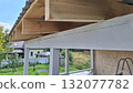 Wooden roof construction detail with timber beams and metal sheeting in residential area 132077782