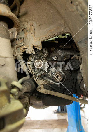 A close-up shot of a dirty and oily car engine 132077832