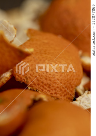 peel of peeled oranges on the table, a large amount of peel of citrus fruits on the table, close up peel of peeled oranges on the table, a large amount of peel of citrus fruits on the table, close up 132077869