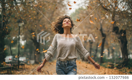 Joyful Woman Embracing the Beauty of Autumn: A Celebration of Freedom, Nature, and the Changing Seasons with Falling Golden Leaves Joyful Woman Embracing the Beauty of Autumn: A Celebration of Freedom, Nature, and the Changing Seasons with Falling Golden Leaves 132077986