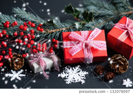Colorful wrapped gifts surrounded by pine branches, berries, and snowflakes create a festive scene for winter celebrations Colorful wrapped gifts surrounded by pine branches, berries, and snowflakes create a festive scene for winter celebrations 132078097