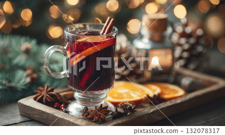 Holiday Mulled Wine: A Steaming Glass of Festive Garnished with Orange and Cinnamon, Served on a Rustic Tray with Star Anise and Twinkling Lights 132078317