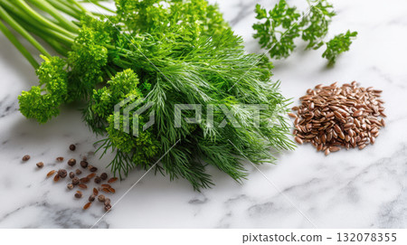close-up of vibrant bundle of fresh dill and curly parsley on a white marble surface, accompanied by piles of flaxseeds. Highlights healthy, natural, fresh ingredients for cooking and nutrition 132078355
