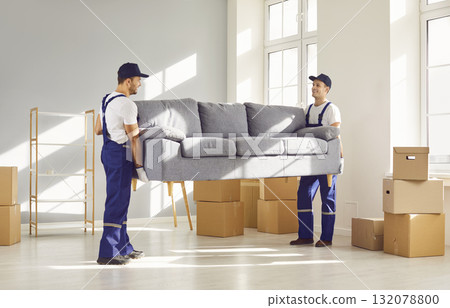 Two workers from delivery service are removing furniture and things from apartment Two workers from delivery service are removing furniture and things from apartment 132078800