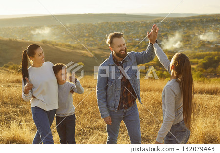 Happy friendly family nature outdoor trip, high five gesture, spending weekend holiday together 132079443