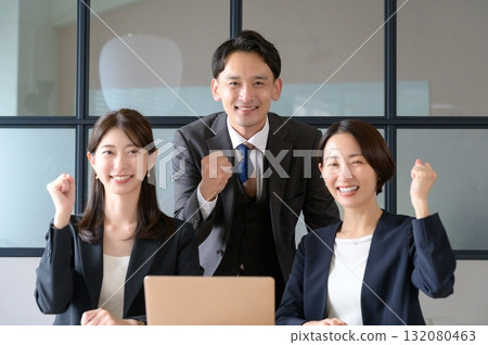 Men and women having a meeting looking at a computer 132080463