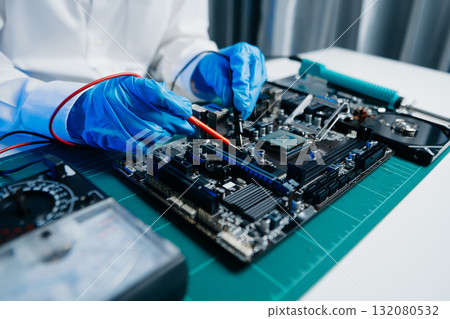 Electronics technician, electronic engineering electronic repair, electronics measuring and testing, repair and maintenance concepts.uses a voltage meter 132080532