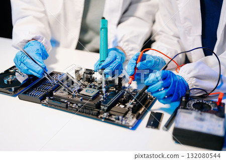 The technician is putting the CPU on the socket of the computer motherboard. electronic engineering electronic repair, electronics measuring 132080544