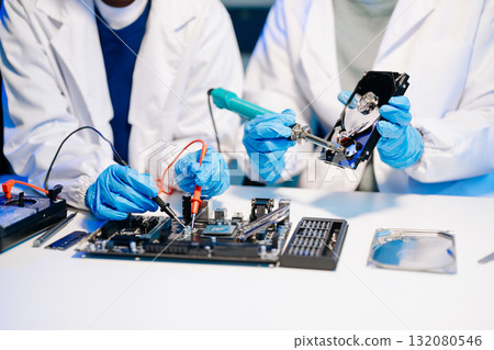 The technician is putting the CPU on the socket of the computer motherboard. electronic engineering electronic repair, electronics measuring 132080546