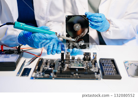Electronics technician, electronic engineering electronic repair, electronics measuring and testing, repair and maintenance concepts.uses a voltage meter to check Electronics technician, electronic engineering electronic repair, electronics measuring and testing, repair and maintenance concepts.uses a voltage meter to check 132080552