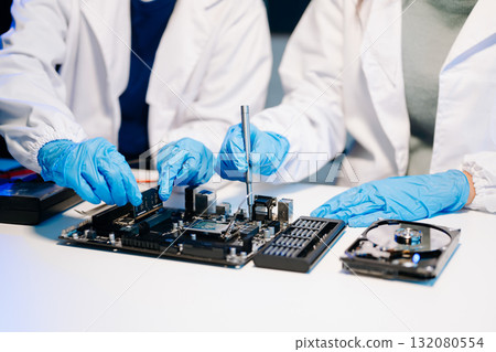The technician is putting the CPU on the socket of the computer motherboard. electronic engineering electronic repair, electronics measuring 132080554