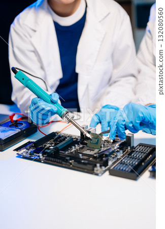 The technician is putting the CPU on the socket of the computer motherboard. electronic engineering electronic repair, electronics measuring 132080560