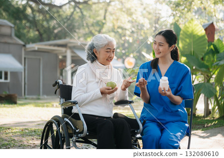 Elderly asian senior woman on wheelchair with Asian careful caregiver. Nursing home hospital Elderly asian senior woman on wheelchair with Asian careful caregiver. Nursing home hospital 132080610