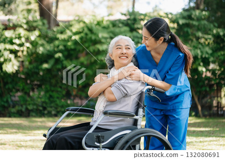 Asian old woman sitting on a wheelchair outdoors in the park Have pain in the arms, wrists and body 132080691