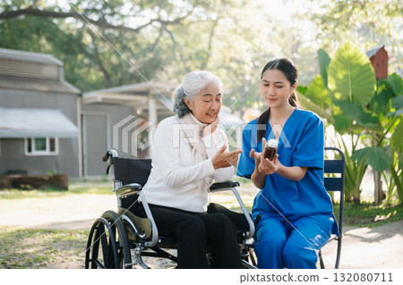 Elderly asian senior woman on wheelchair with Asian careful caregiver. Nursing home hospital 132080711