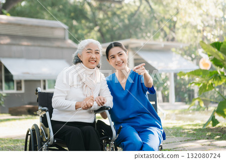 Asian young caregiver nurse support senior older male walking outdoors. Specialis doctor help and take care of elderly mature. Asian young caregiver nurse support senior older male walking outdoors. Specialis doctor help and take care of elderly mature. 132080724