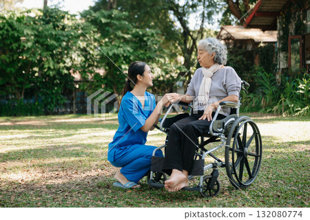 Asian physiotherapist helping elderly woman patient stretching arm during exercise correct with dumbbell in hand during training hand with patient Back problems in the garden. Asian physiotherapist helping elderly woman patient stretching arm during exercise correct with dumbbell in hand during training hand with patient Back problems in the garden. 132080774