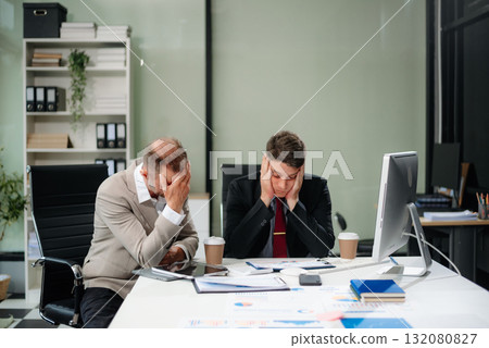 Furious two Asian businesspeople arguing strongly after making a mistake at work Furious two Asian businesspeople arguing strongly after making a mistake at work 132080827