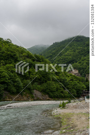 Thick clouds over the mountains, a river between the mountains, Georgia 132081384