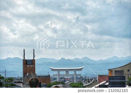 Summer scenery with cumulonimbus clouds and a cityscape with a large torii gate 132082183