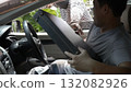 Masked thief reaching into a car window trying to steal a briefcase from a frightened driver. Concept of car robbery, theft, danger, urban crime, and personal security awareness 132082926