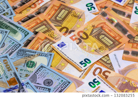 Colorful mix of European and American currency scattered on a flat surface Colorful mix of European and American currency scattered on a flat surface 132083255