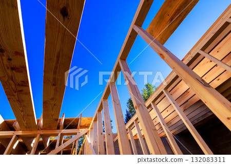 Workers are framing structure with wooden beams in construction site Workers are framing structure with wooden beams in construction site 132083311