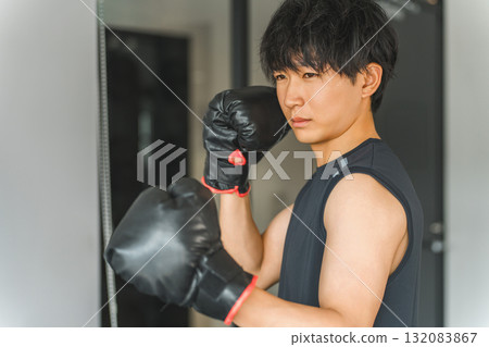 Gym, young Asian man doing boxing exercises at training gym 132083867