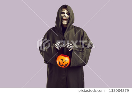 Scary man with skull makeup in hooded black cloak Scary man with skull makeup in hooded black cloak 132084279