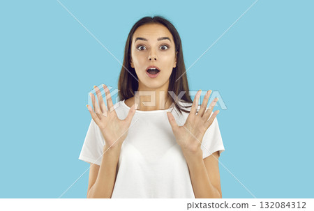 Young woman looking at the camera with a surprised, shocked, happy face expression Young woman looking at the camera with a surprised, shocked, happy face expression 132084312