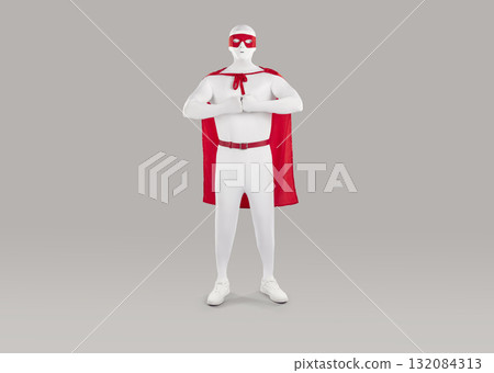Man in red superhero cape, red eye mask and white bodysuit standing on gray background 132084313