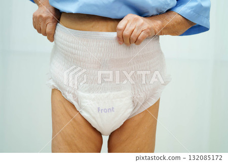 Asian senior woman patient wearing adult incontinence diaper pad in hospital. Asian senior woman patient wearing adult incontinence diaper pad in hospital. 132085172